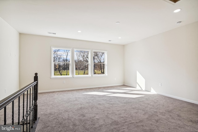 unfurnished room with light carpet