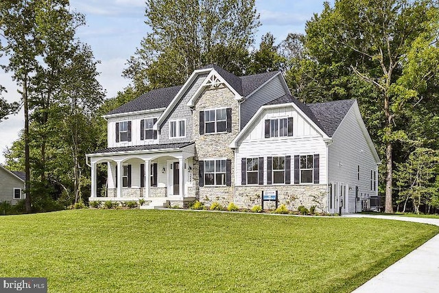 craftsman inspired home featuring central AC, a front lawn, and covered porch