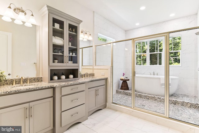 bathroom featuring tile walls, double vanity, tile floors, and independent shower and bath