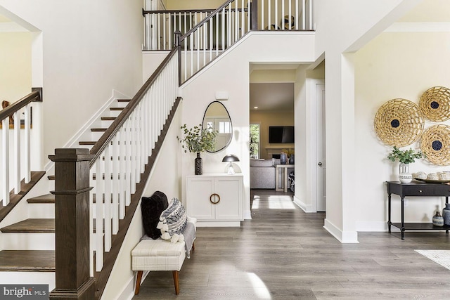 interior space featuring light hardwood / wood-style floors and a towering ceiling