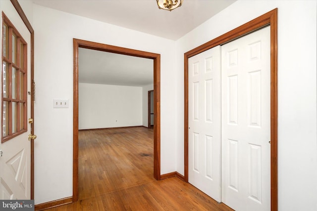 hall with hardwood / wood-style floors