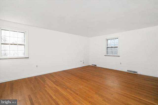 empty room with hardwood / wood-style floors