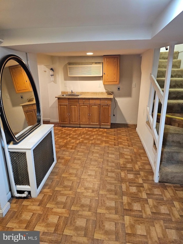 kitchen featuring radiator, sink, and light parquet flooring