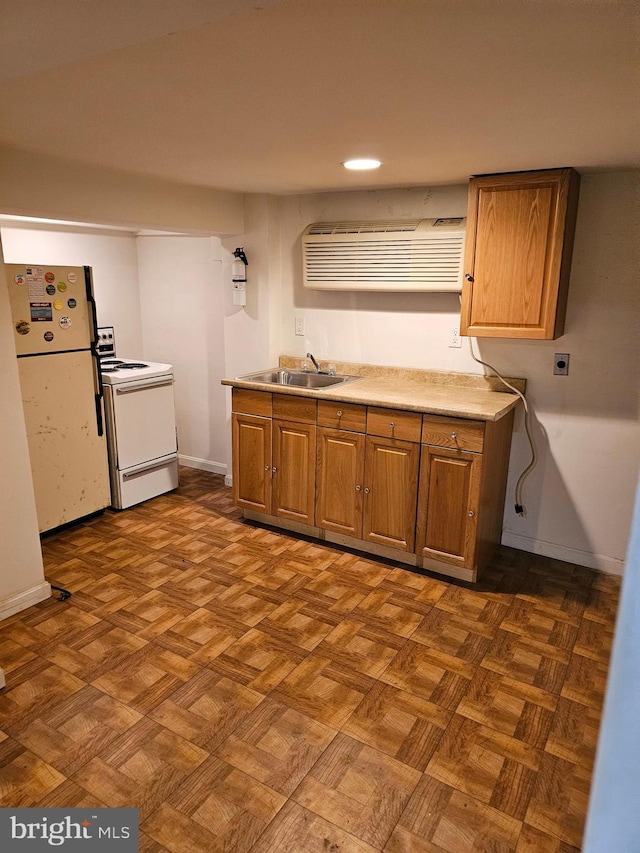 kitchen with dark parquet floors, white appliances, and sink