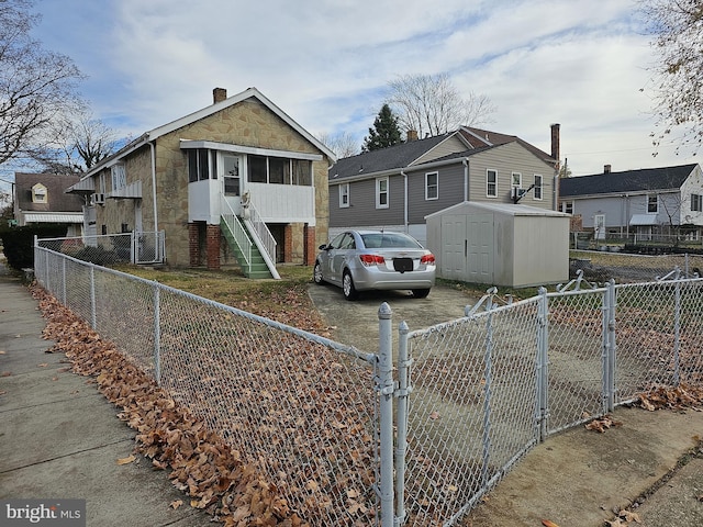 view of front of home featuring a storage unit