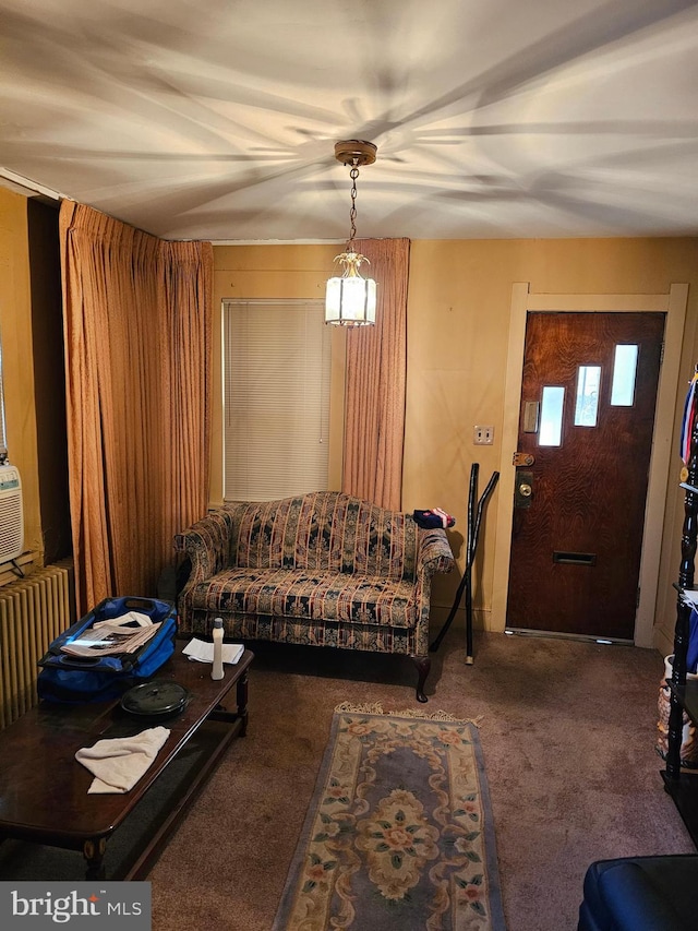 living room with dark carpet and radiator heating unit