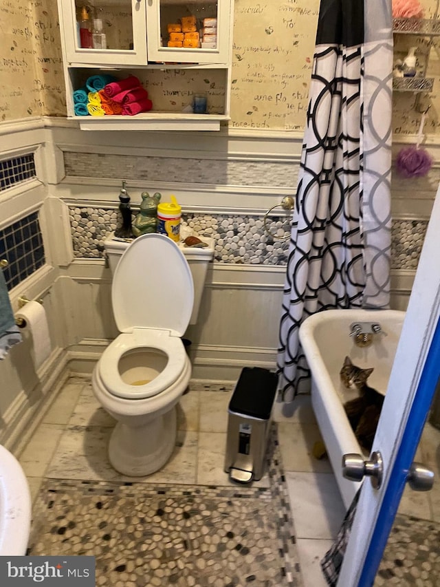 bathroom with toilet and tile flooring