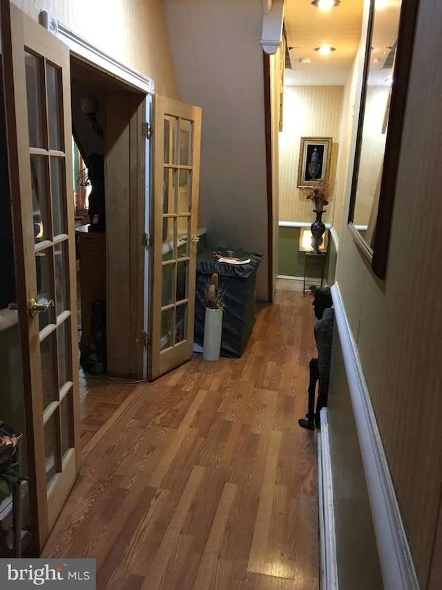 corridor featuring french doors and hardwood / wood-style floors