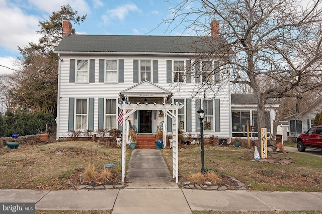 colonial inspired home with a front yard