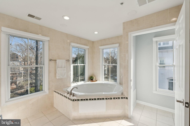 bathroom featuring tiled tub and tile patterned floors