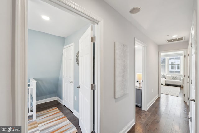 hall with dark hardwood / wood-style flooring