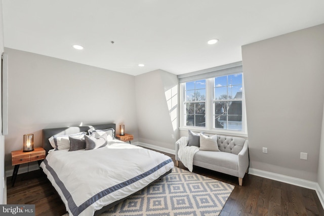 bedroom with dark hardwood / wood-style flooring