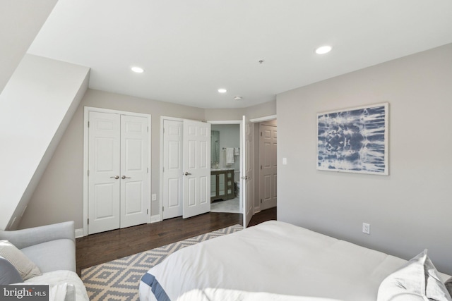 bedroom featuring multiple closets and dark hardwood / wood-style flooring