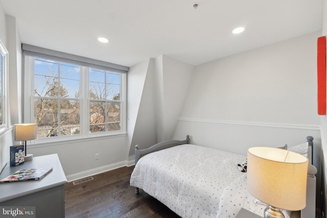 bedroom with dark hardwood / wood-style floors