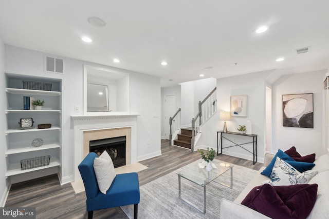 living room featuring hardwood / wood-style flooring and built in features