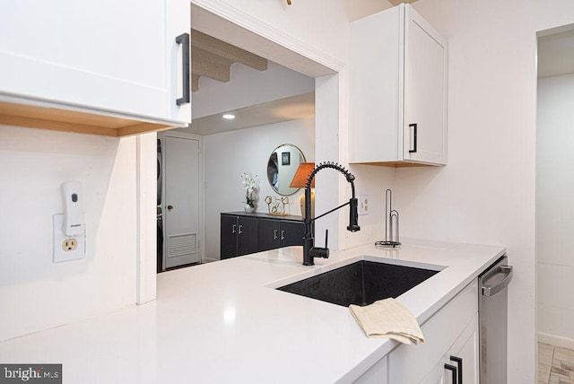 kitchen with white cabinets, dishwasher, and sink