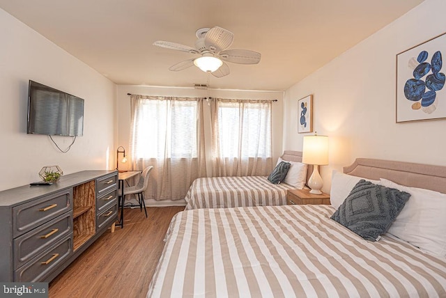 bedroom featuring ceiling fan and dark hardwood / wood-style floors