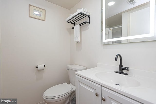 bathroom with toilet and vanity