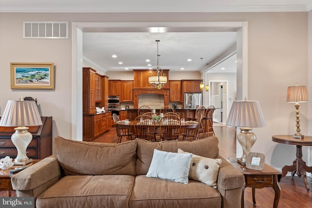 living room with dark hardwood / wood-style floors and crown molding