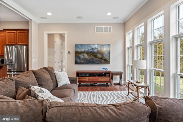 living room featuring crown molding and hardwood / wood-style flooring