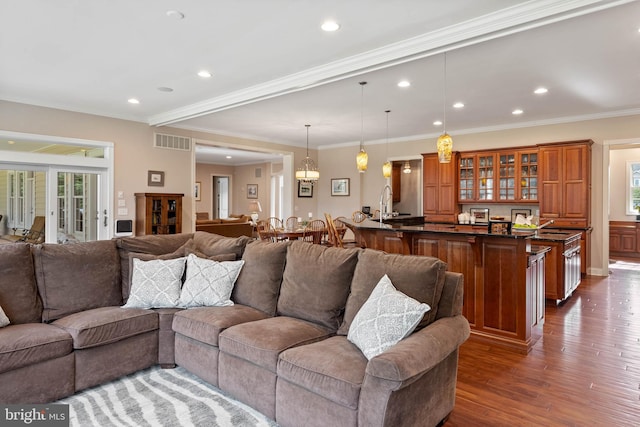 living room with ornamental molding, dark hardwood / wood-style floors, and french doors