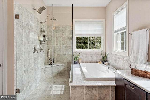 bathroom featuring vanity and plus walk in shower