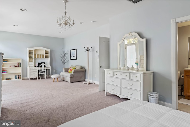 carpeted bedroom with connected bathroom and an inviting chandelier