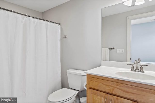 bathroom featuring toilet and vanity