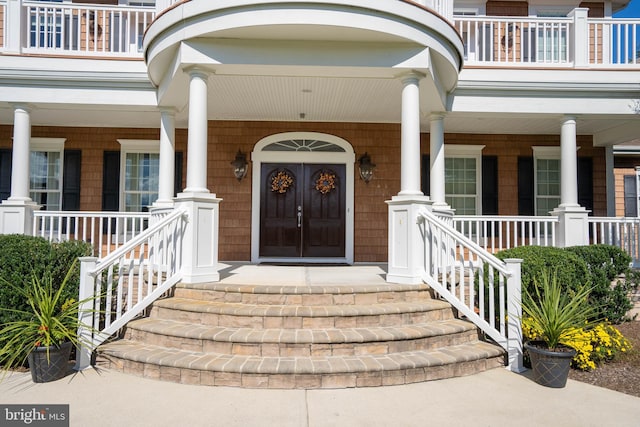 view of exterior entry with a porch