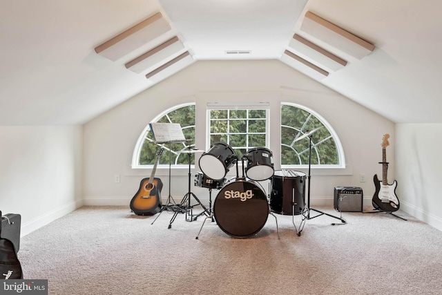 workout room with light carpet and vaulted ceiling