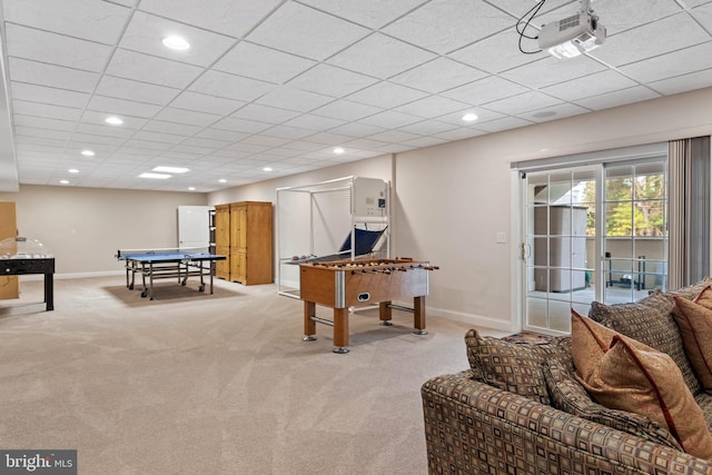 playroom featuring a paneled ceiling and light carpet