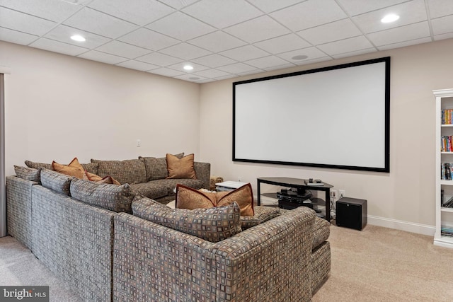 home theater room with a drop ceiling and light colored carpet