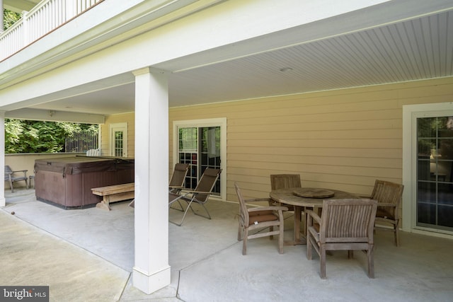 view of terrace with a hot tub