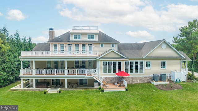 back of house featuring central AC unit, a yard, and a patio