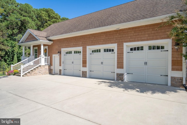 exterior space with a porch and a garage