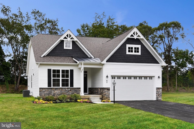 craftsman inspired home featuring a front yard and central air condition unit