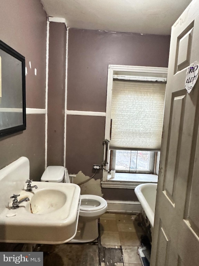 bathroom with sink, a washtub, tile flooring, and toilet