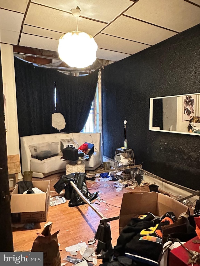 miscellaneous room with a paneled ceiling and light hardwood / wood-style floors