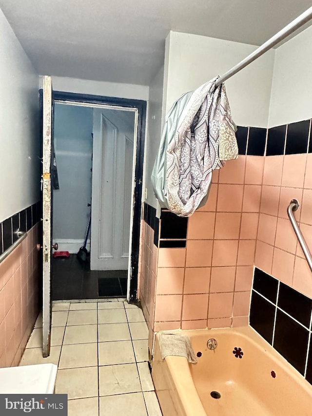 bathroom featuring tile floors and tile walls