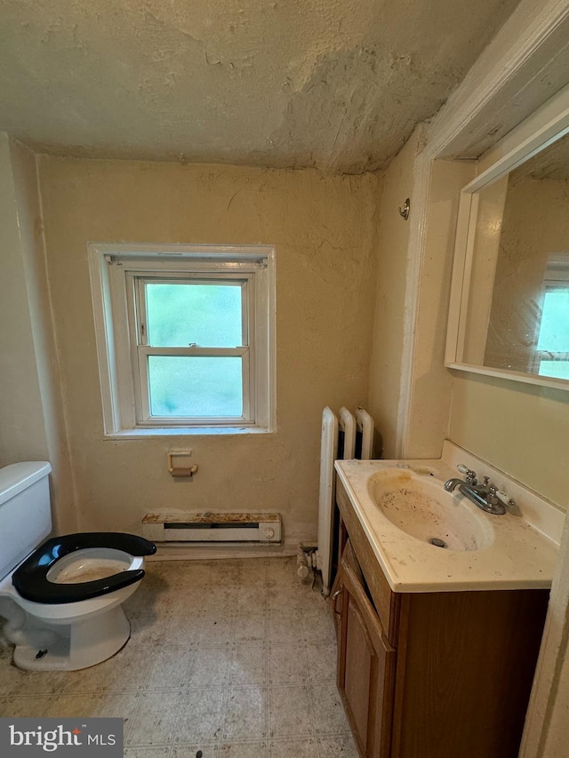 bathroom with radiator heating unit, vanity, toilet, and a baseboard heating unit