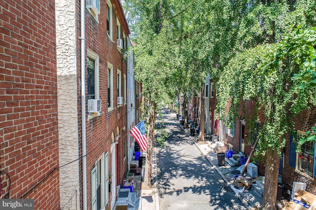 view of property exterior featuring cooling unit and a wall mounted AC