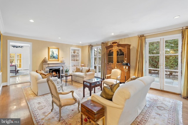 living room featuring crown molding and light hardwood / wood-style flooring