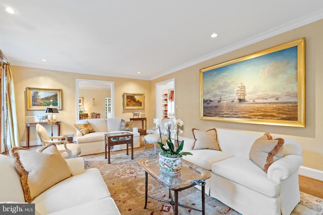 living room with crown molding and light wood-type flooring