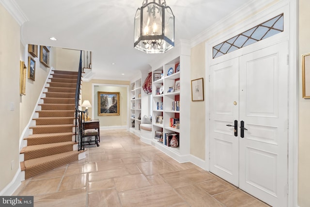 foyer entrance featuring light tile flooring, a notable chandelier, and ornamental molding