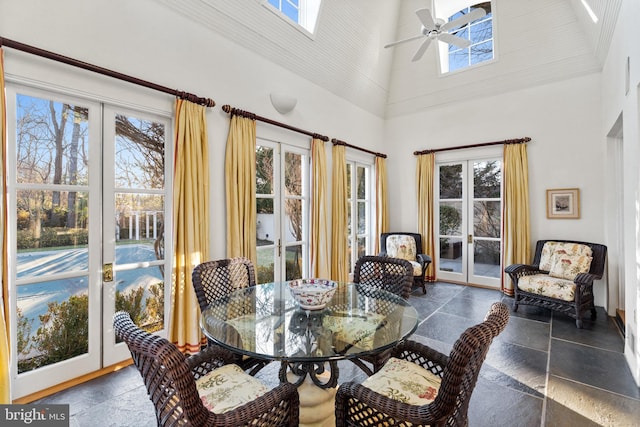 dining room featuring french doors, dark tile floors, high vaulted ceiling, and ceiling fan