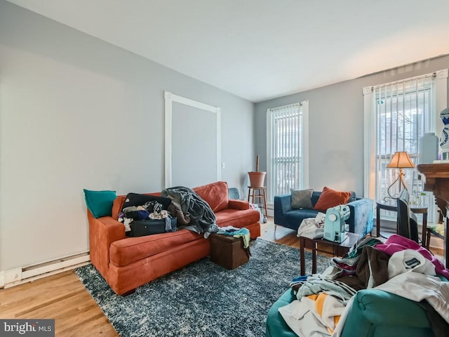 living room featuring wood-type flooring and baseboard heating