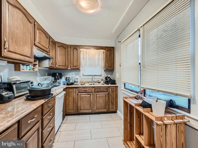 kitchen featuring light tile patterned floors and sink