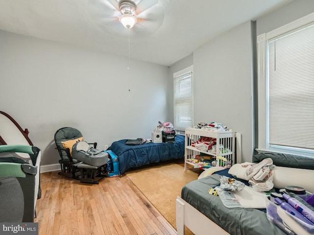 bedroom with light hardwood / wood-style flooring and ceiling fan