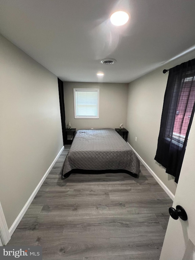 bedroom featuring dark hardwood / wood-style flooring