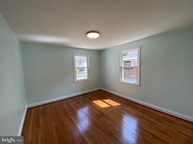 unfurnished room featuring dark wood-type flooring